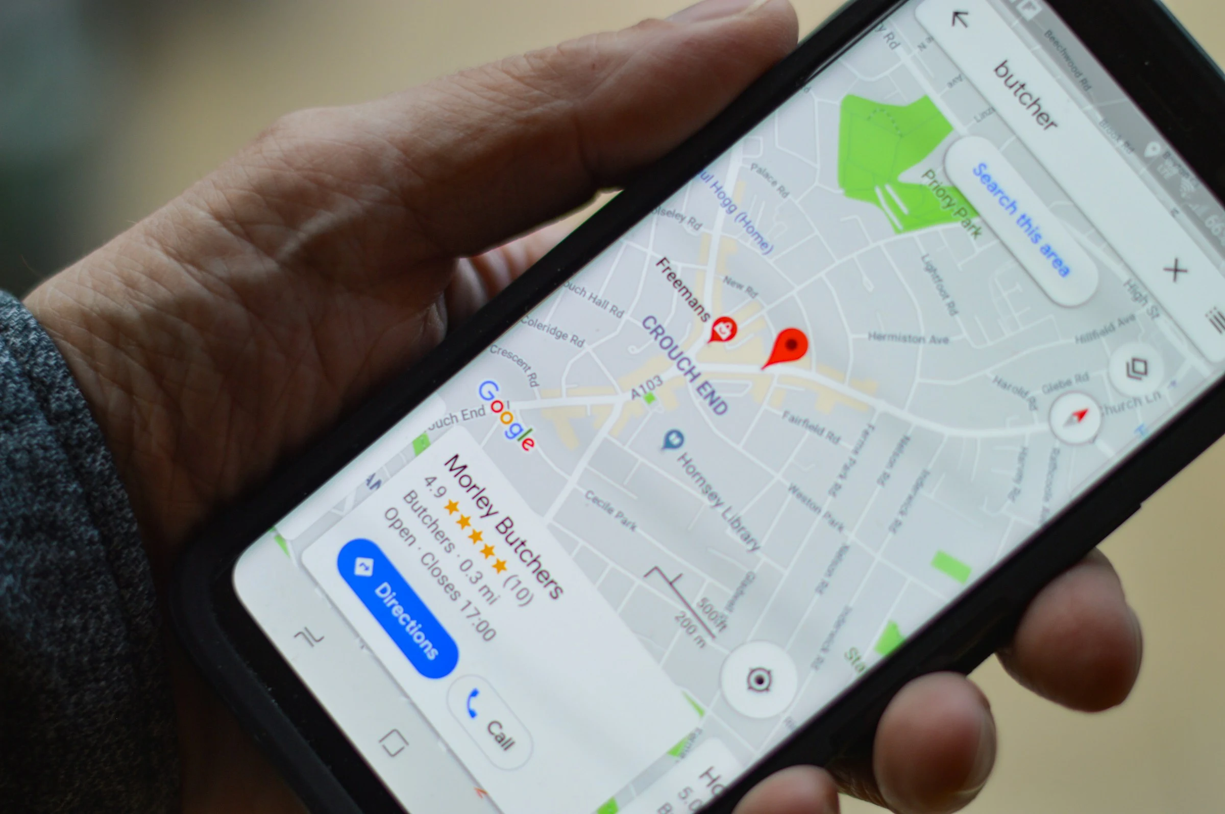 A person using a local business map on a smartphone.