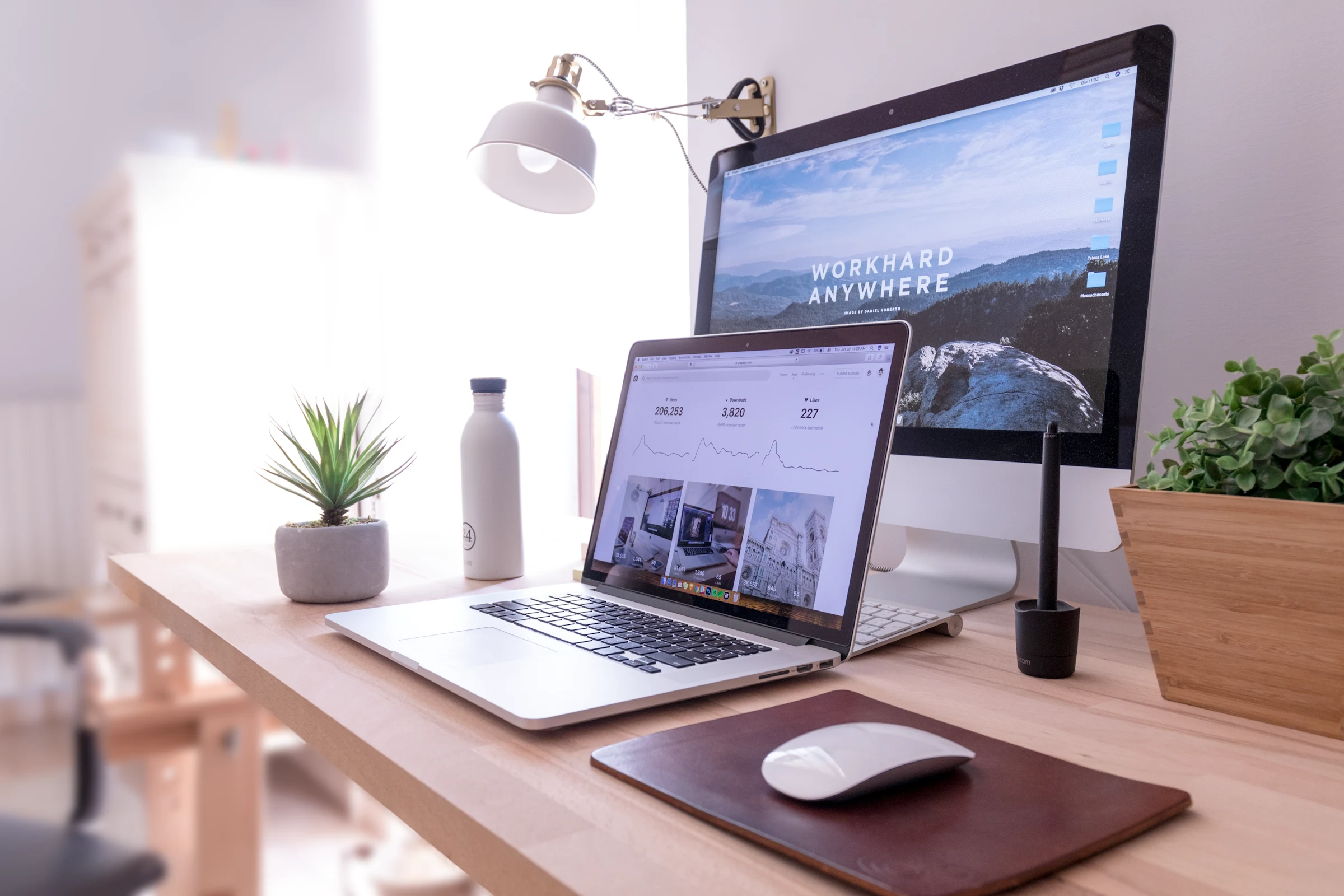 A website displayed across a desktop monitor and laptop.